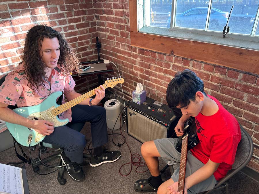 Student and teacher during a guitar lesson